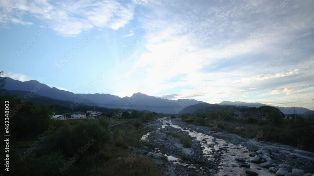 Walking on the bridge. Mountains and a river after sunset Walking on the bridge. Mountains and a river after sunset