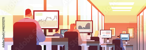 mix race traders stock market brokers analyzing charts or making presentation on computer monitors at workplace