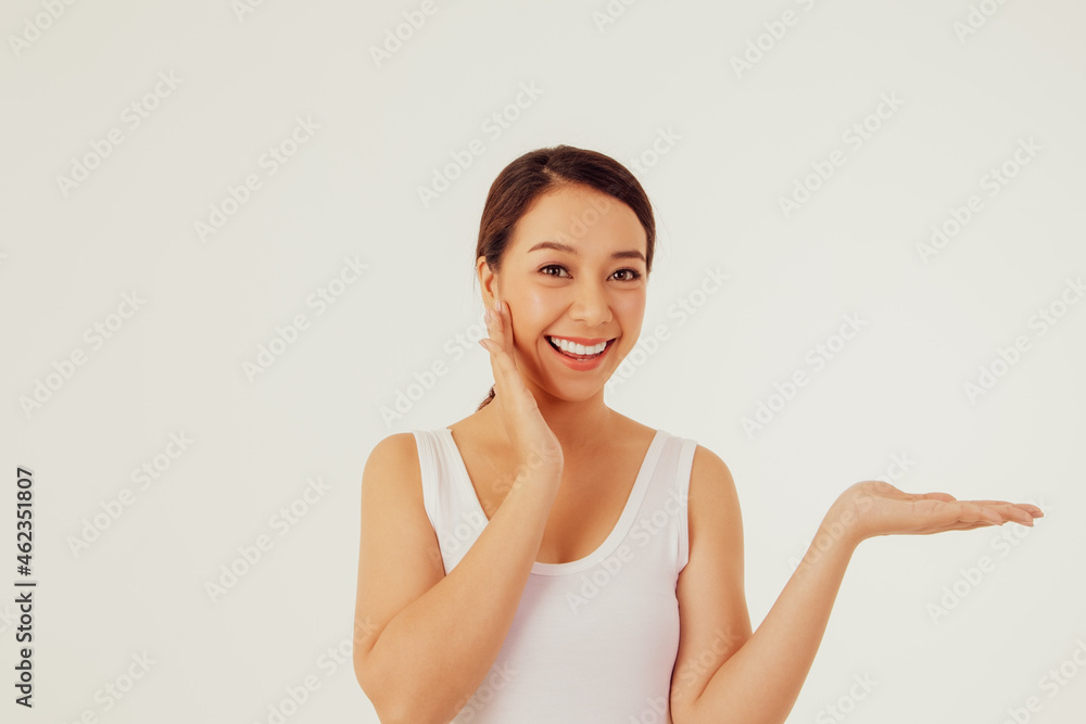 Young Asian woman, hand touching face, beautiful, clean and with a smile, looking at the camera with fun emotions. Young Asian woman, hand touching face, beautiful, clean and with a smile, looking at the camera with fun emotions.