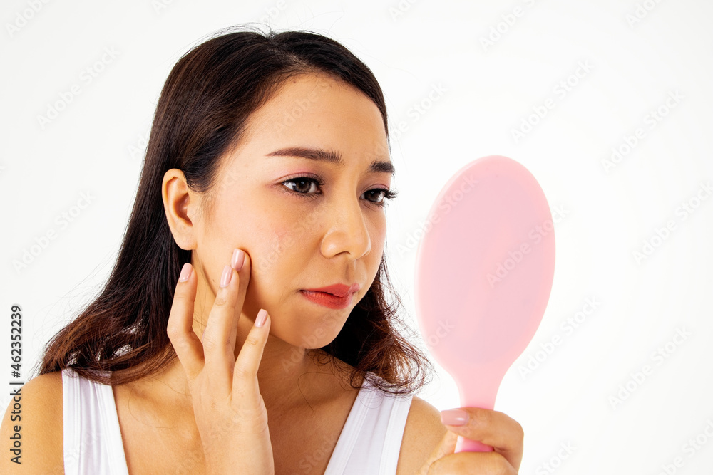 Concept Asian girls have acne : Portrait Long-haired girl anxious on facial beauty Looked in the mirror to see the faces, their right cheeks were wrinkles And dark spots from acne are noticeable Concept Asian girls have acne : Portrait Long-haired girl anxious on facial beauty Looked in the mirror to see the faces, their right cheeks were wrinkles And dark spots from acne are noticeable