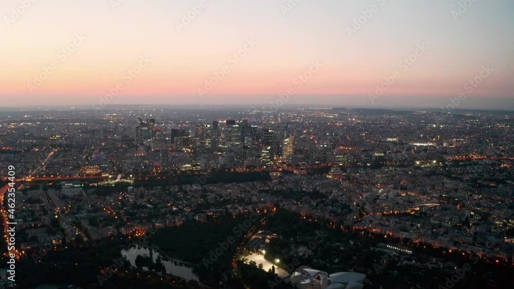 Circling dolly back drone shot of La Defence Paris business district at dusk Circling dolly back drone shot of La Defence Paris business district at dusk