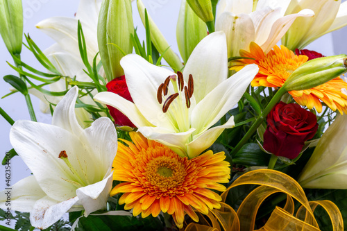 Принти на полотні A beautiful bouquet of white lilies and orange gerberas
