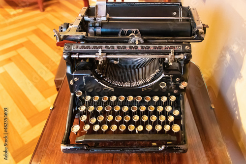 An old vintage Typewriter with spanish keyboard over a wooden desk.
