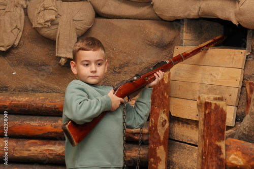 a child with a World War II rifle
