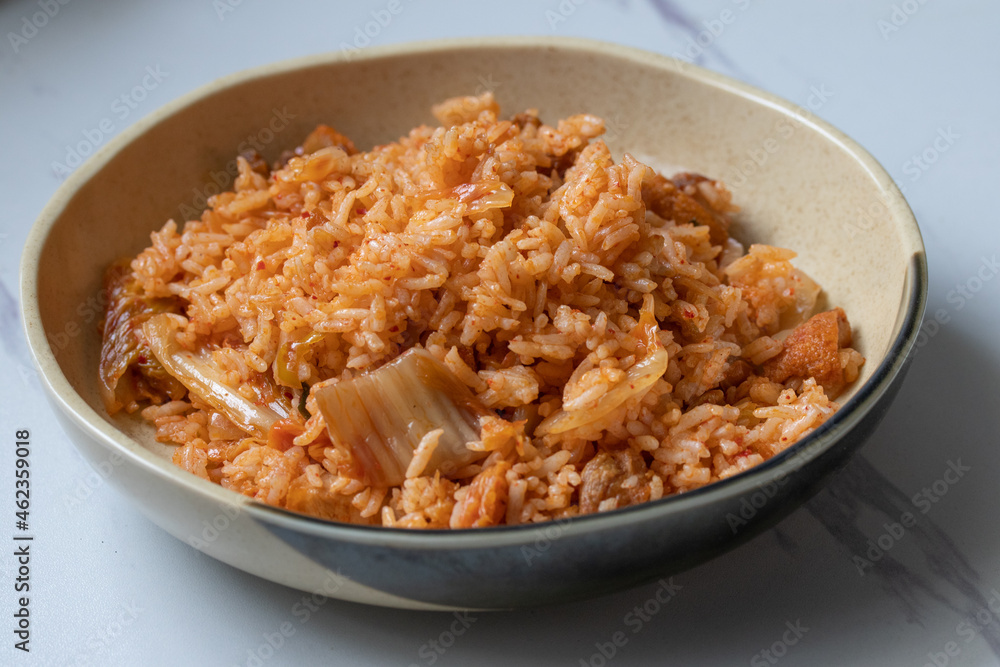 Kimchi fried rice in ceramic plate on white background Kimchi fried rice in ceramic plate on white background