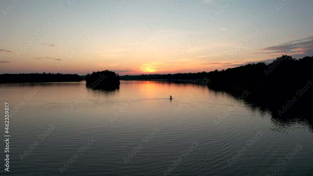 Backlit fisherman fishing in a beautiful landscape, Netherlands Backlit fisherman fishing in a beautiful landscape, Netherlands