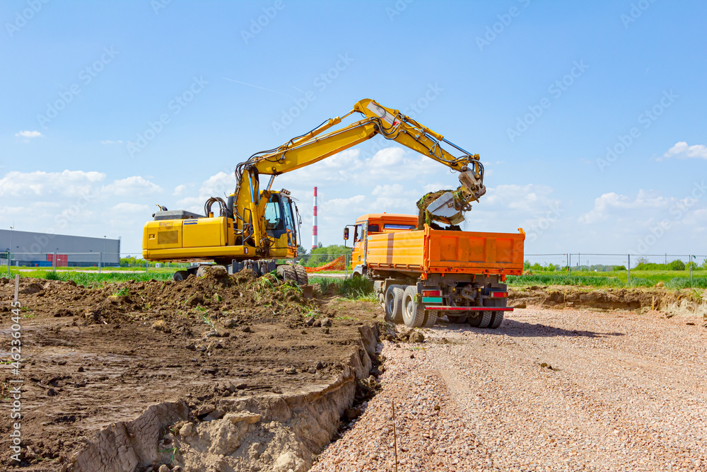 Excavator is digging on building site Excavator is digging on building site