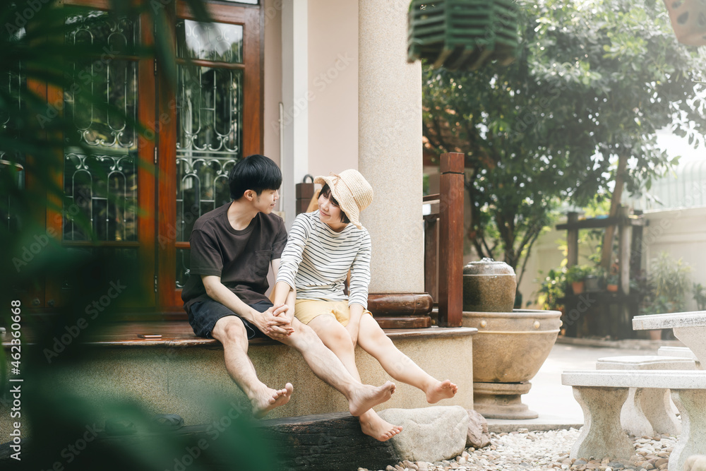 Young adult asian lover couple together living at home garden terrace on day.