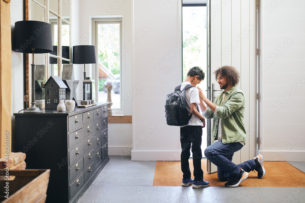 Father helping son get ready for school Father helping son get ready for school