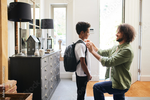 Father helping son get ready for school photo