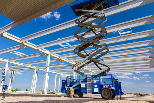 Mobile scaffold, stretched scissor lift platform at construction site