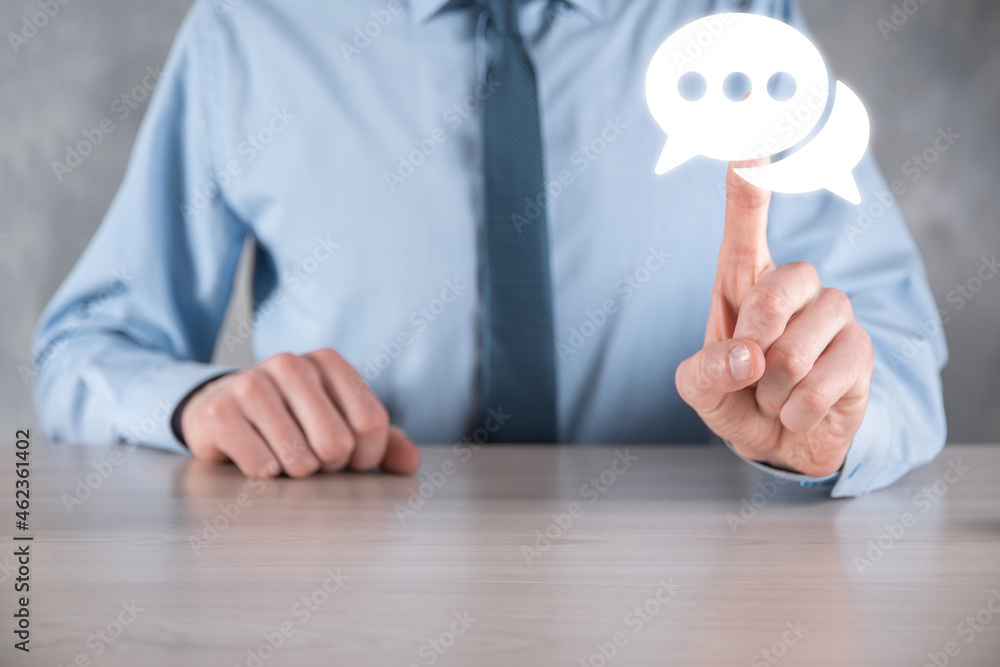 Businessman holding a message icon, bubble talk notification sign in his hands. Chat icon, sms icon, comments icon, speech bubbles Businessman holding a message icon, bubble talk notification sign in his hands. Chat icon, sms icon, comments icon, speech bubbles