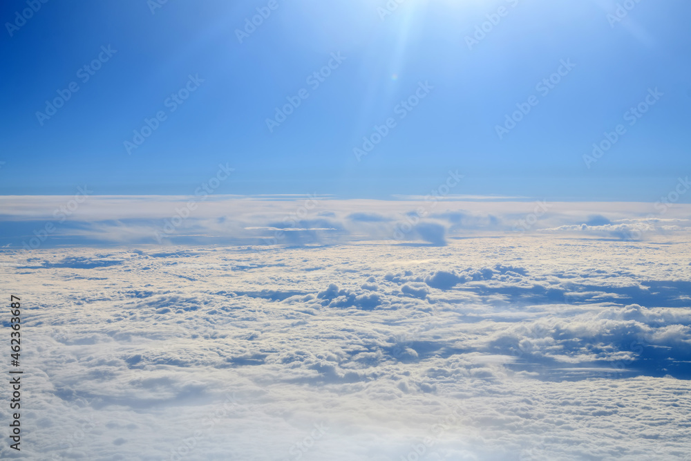 Obraz premium Clouds and sky as seen through window of an aircraft