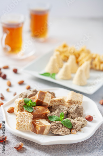 Oriental sweetness. Nougat, halva and tea on a table.