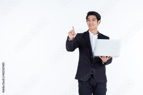Obraz na płótnie successful Happy of asian young businessman a successful business hold laptop computer with pointing hand gestures finger touch imagery panel isolated on white grey blank copy space studio background w salonie