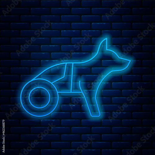 Glowing neon line Paralyzed dog in wheelchair icon isolated on brick wall background. Vector