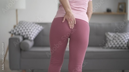 Hemorrhoidal pain, woman suffering from hemorrhoids at home