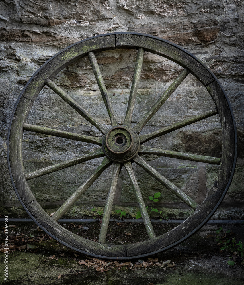Old and vintage cartwheel at stone wall