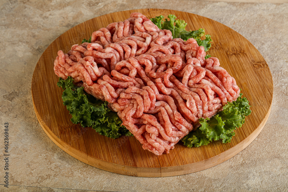 Raw pork minced meat over board Raw pork minced meat over board