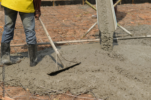 Workers pour concrete for construction.