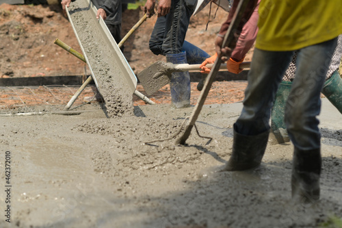Workers pour concrete for construction.