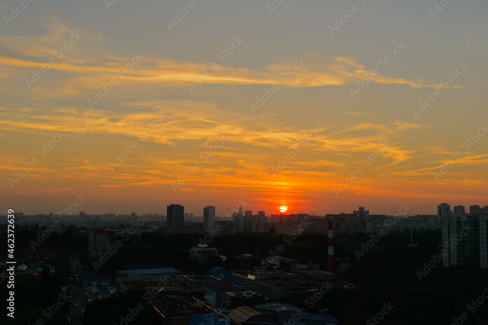 Evening panorama of the city with the setting sun