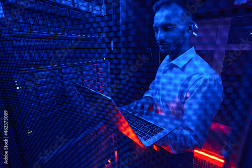 Server technician doing rack examination with laptop