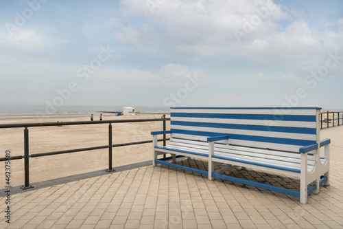 Empty bench on the beach against the background of the sea. © KiNOVO