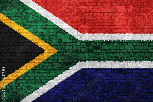 Wall of bricks painted with flag of South Africa, blue red black, white and yellow colors. 3D background. Concept of social barriers of immigration, divisions, and political conflicts in South Africa