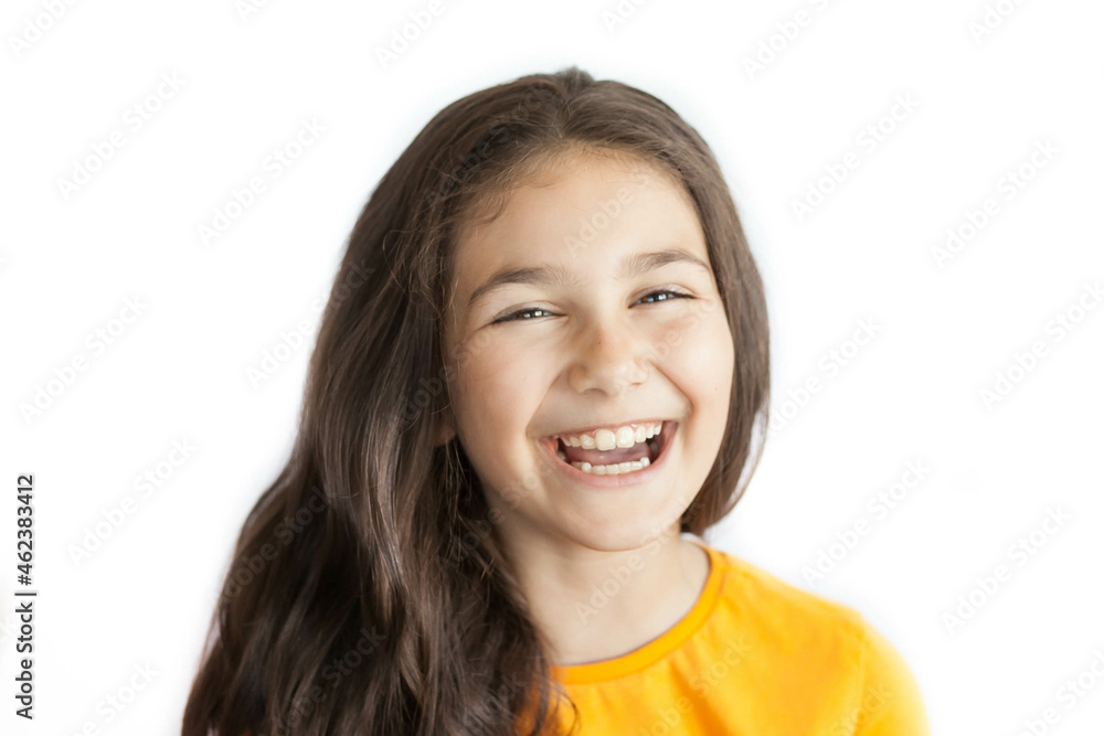 Happy positive smiling child girl with a long hair in yellow T-shirt isolated on white background Happy positive smiling child girl with a long hair in yellow T-shirt isolated on white background