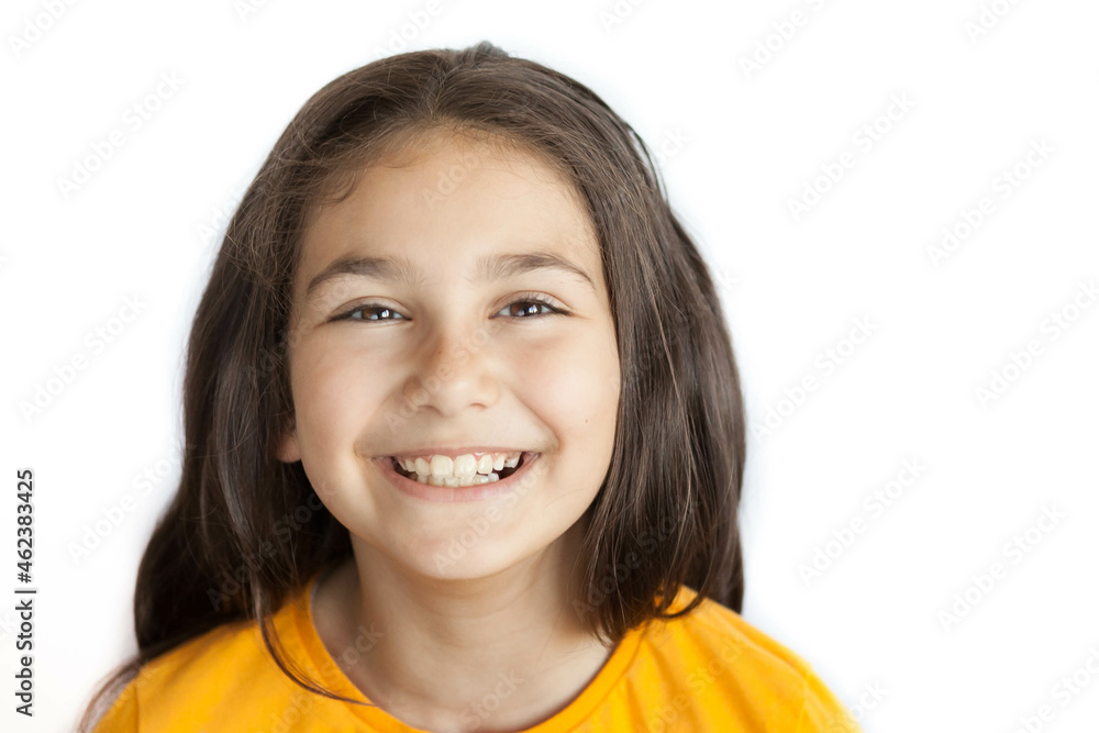 Happy positive smiling child girl with a long hair in yellow T-shirt isolated on white background Happy positive smiling child girl with a long hair in yellow T-shirt isolated on white background