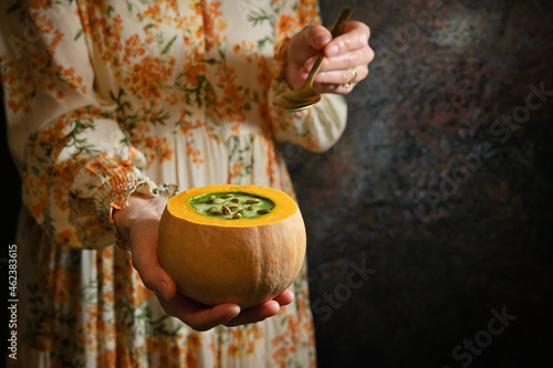Woman holding Healthy Pumpkin Cream Soup