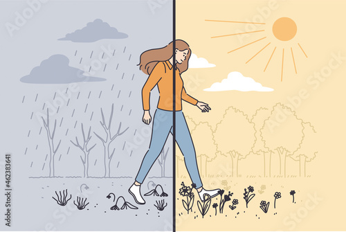 Variety of nature weather concept. Young woman cartoon character making step from gloomy grey rainy weather to sunny clear day vector illustration 