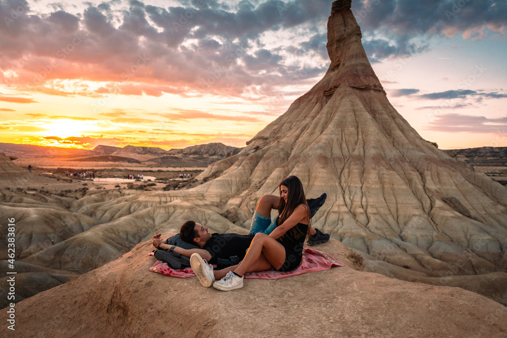 Φωτογραφία One young man and one young woman watching the sunset at Castildetierra in Bardenas Reales desert, Navarra, Basque Country