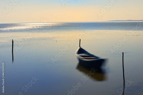 Long exposure Boat In The Calm Water on Razim Lake photo