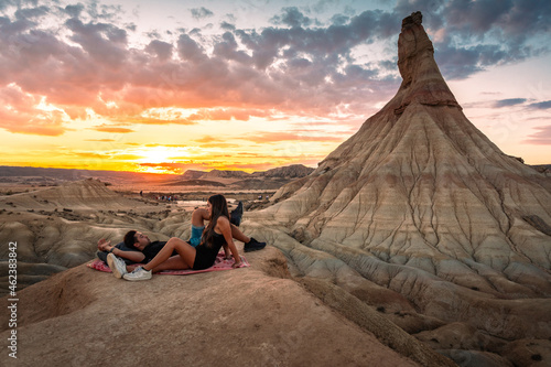 One young man and one young woman watching the sunset at Castildetierra in Bardenas Reales desert, Navarra, Basque Country. photo