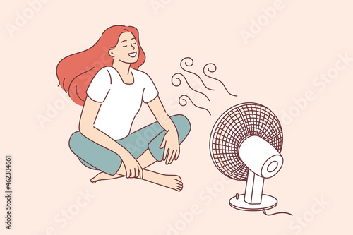 Enjoying cool wind waves concept. Young smiling woman cartoon character sitting on floor catching enjoying cool wind from fan vector illustration 