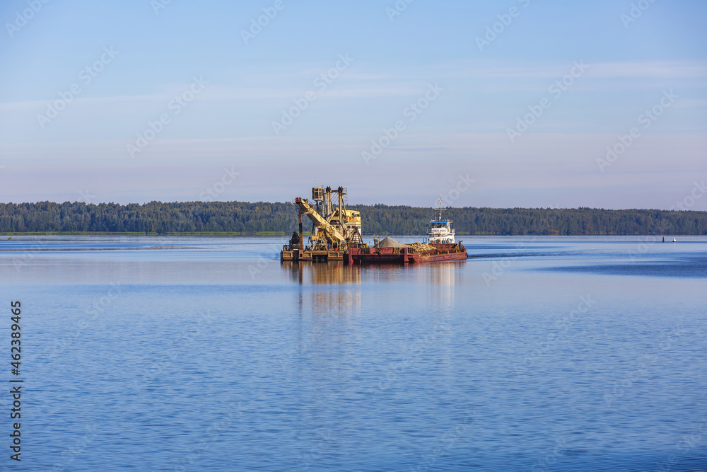 Tugboat Captain Petrov and a barge with sand float on the Volga River. Yaroslavl Region, Russia