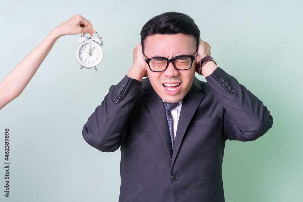 Young Asian businessman posing on green background Young Asian businessman posing on green background