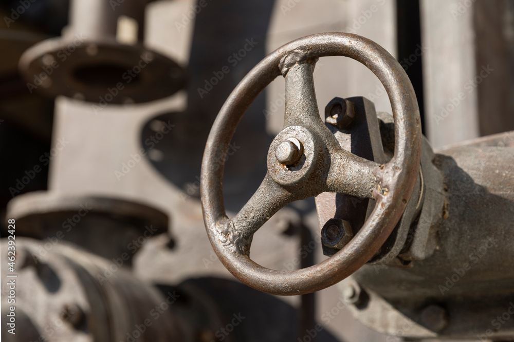 Old rusty valves of industrial oven from steam revolution times with pipes all in steampunk climate Old rusty valves of industrial oven from steam revolution times with pipes all in steampunk climate