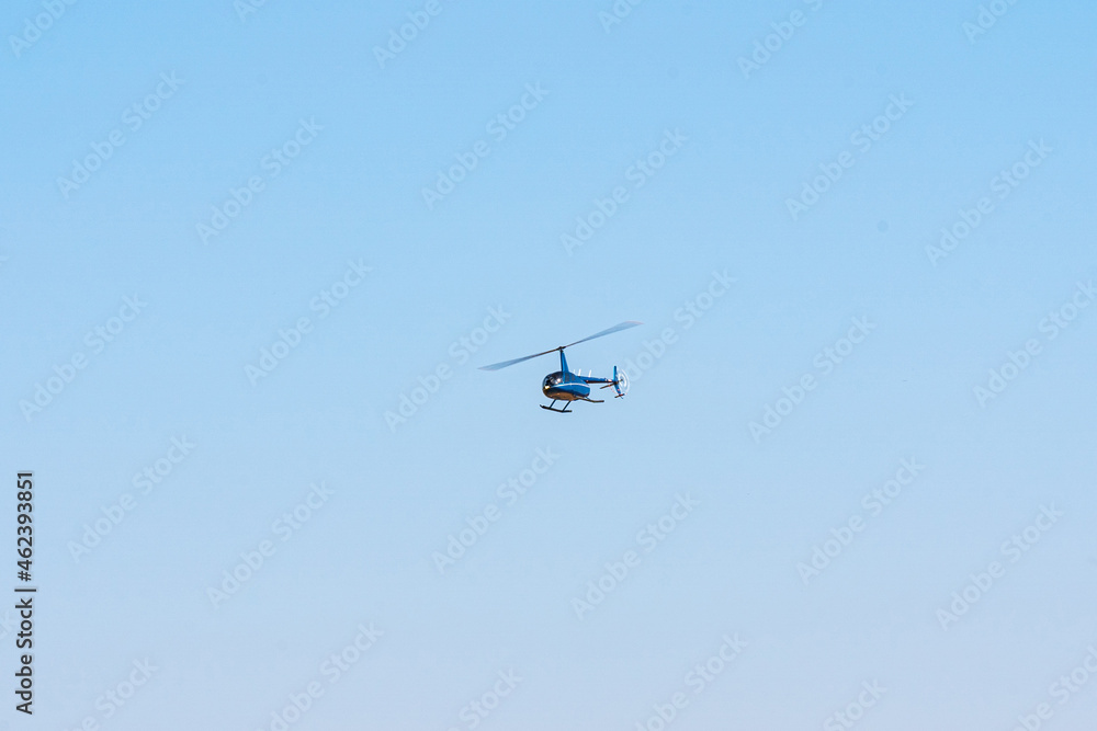 Helicopter flying in the sky during a sunny day Helicopter flying in the sky during a sunny day