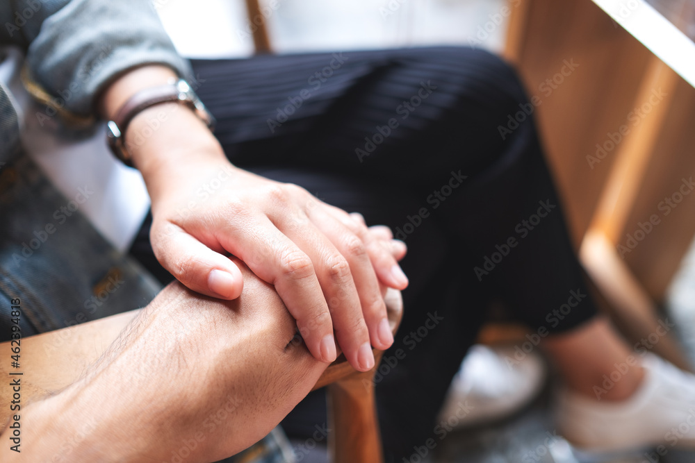 A man and a woman holding each other hands for love and care