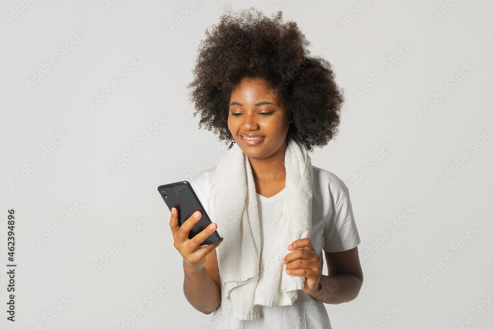 portrait of african female in white t-shirt with mobile phone portrait of african female in white t-shirt with mobile phone