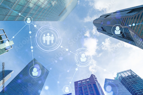 Photography Social media icons hologram over low angle shot of Singapore skyscrapers, Southeast Asia