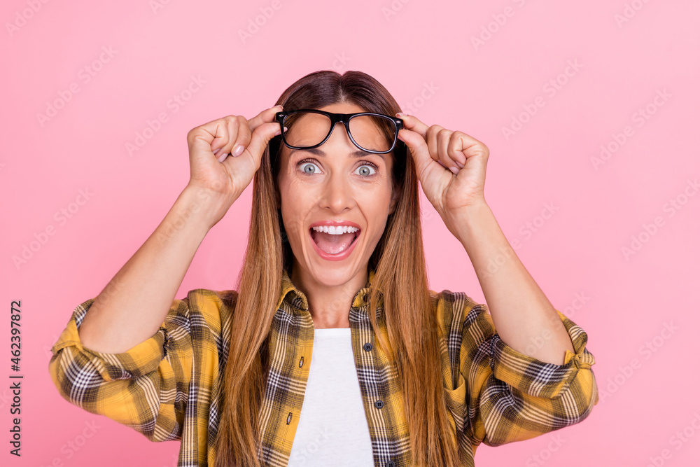 Photo of amazed shcoedk young happy woman wear glasses face eyewear enjoy astonished isolated on pink color background Photo of amazed shcoedk young happy woman wear glasses face eyewear enjoy astonished isolated on pink color background