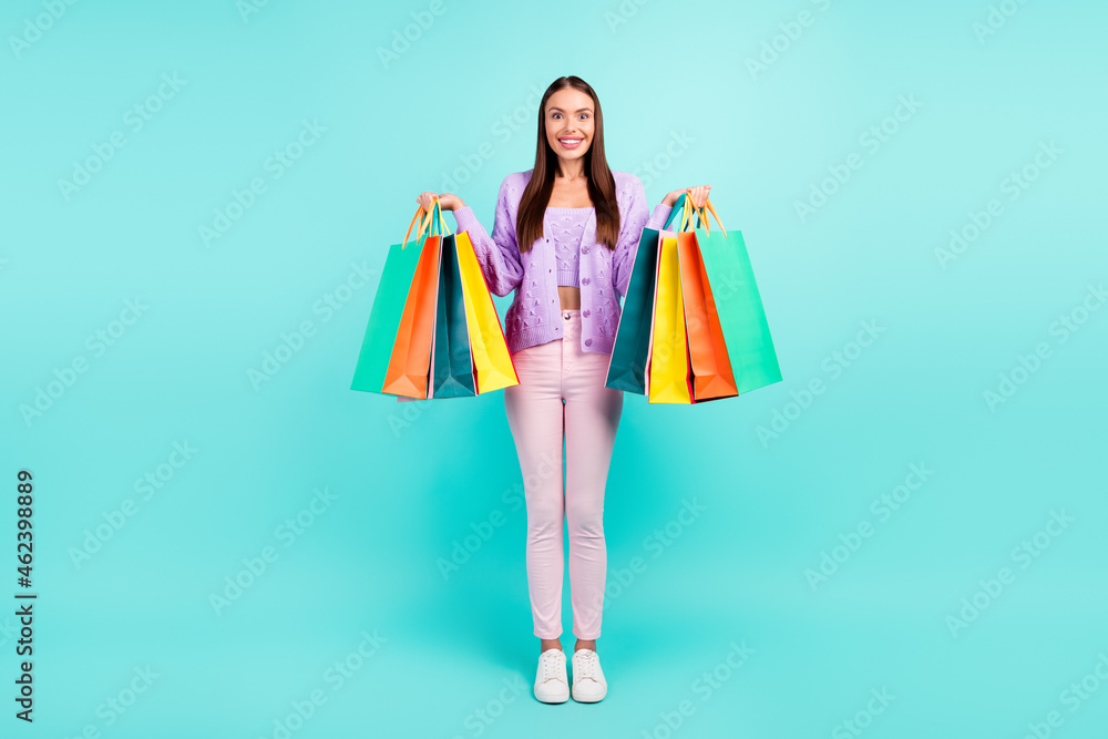 Photo of cheerful customer lady hold retail packages wear violet cardigan isolated turquoise color background Photo of cheerful customer lady hold retail packages wear violet cardigan isolated turquoise color background