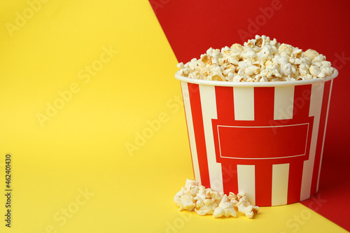 Striped paper cup with popcorn on two tone background