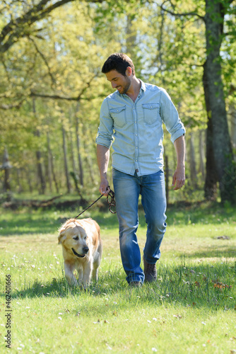Photography man walking a dog in the park