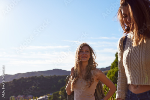 Cheerful female friends going hiking together