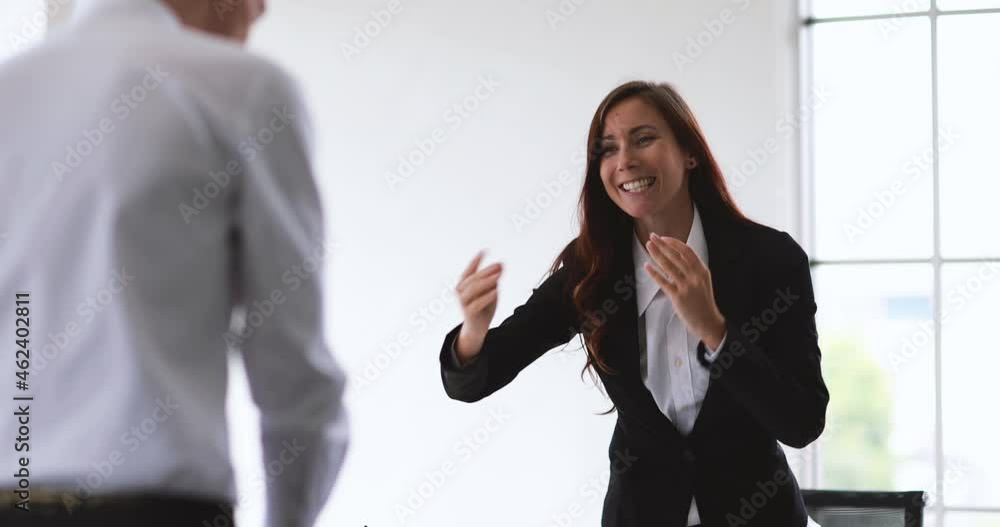 Female Caucasian business people stand up for greeting say hello to businessman visitor and make a handshake and discuss about work in office. Concept for team relationship. Female Caucasian business people stand up for greeting say hello to businessman visitor and make a handshake and discuss about work in office. Concept for team relationship.